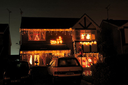 Picture of a house with Christmas lights and Santa Claus
