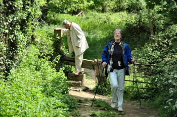 Picture of my parents climbing over a stile