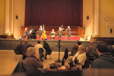 Picture of a hall with an orchestra on the stage