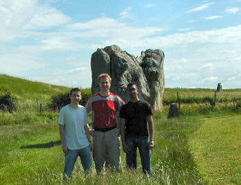 Picture of three people in front of some standing stones