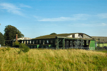 One of the old hangars, the roof partly collapsed (and the rest not in much better state) Picture of a disused hangar, roof partly collapsed