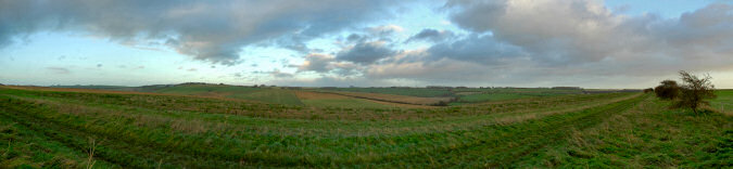 Picture of a panoramic view over fields and hill
