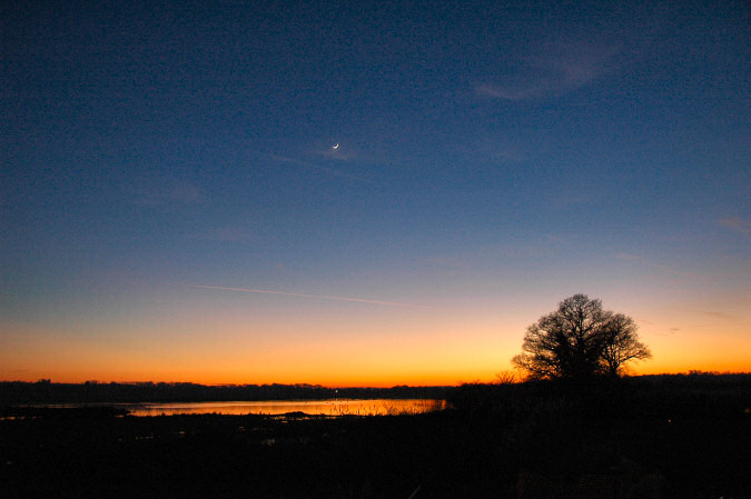Picture of the last evening light with a new moon in the clear sky