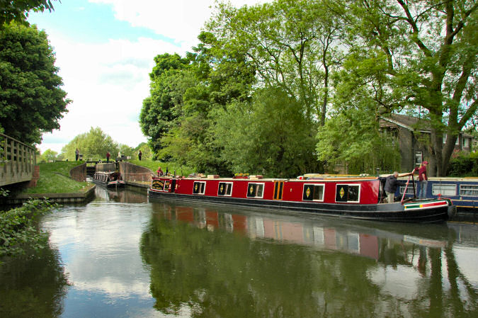 Picture of two boats coming out of a lock at a canal