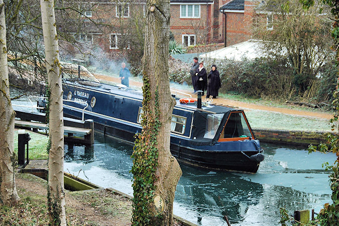 Picture of a canal boat leaving a lock during the winter