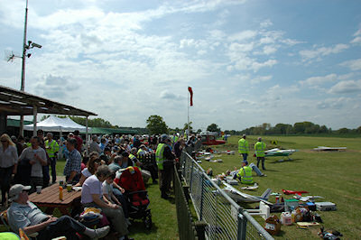 Picture of visitors at a small airshow next to the landing strip