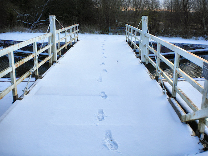 Picture of footsteps in the snow on the bridge