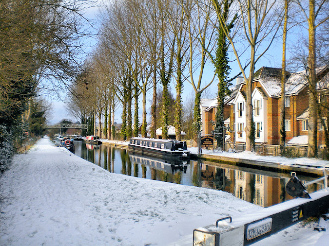 Picture of an apartment block next to a canal in the snow